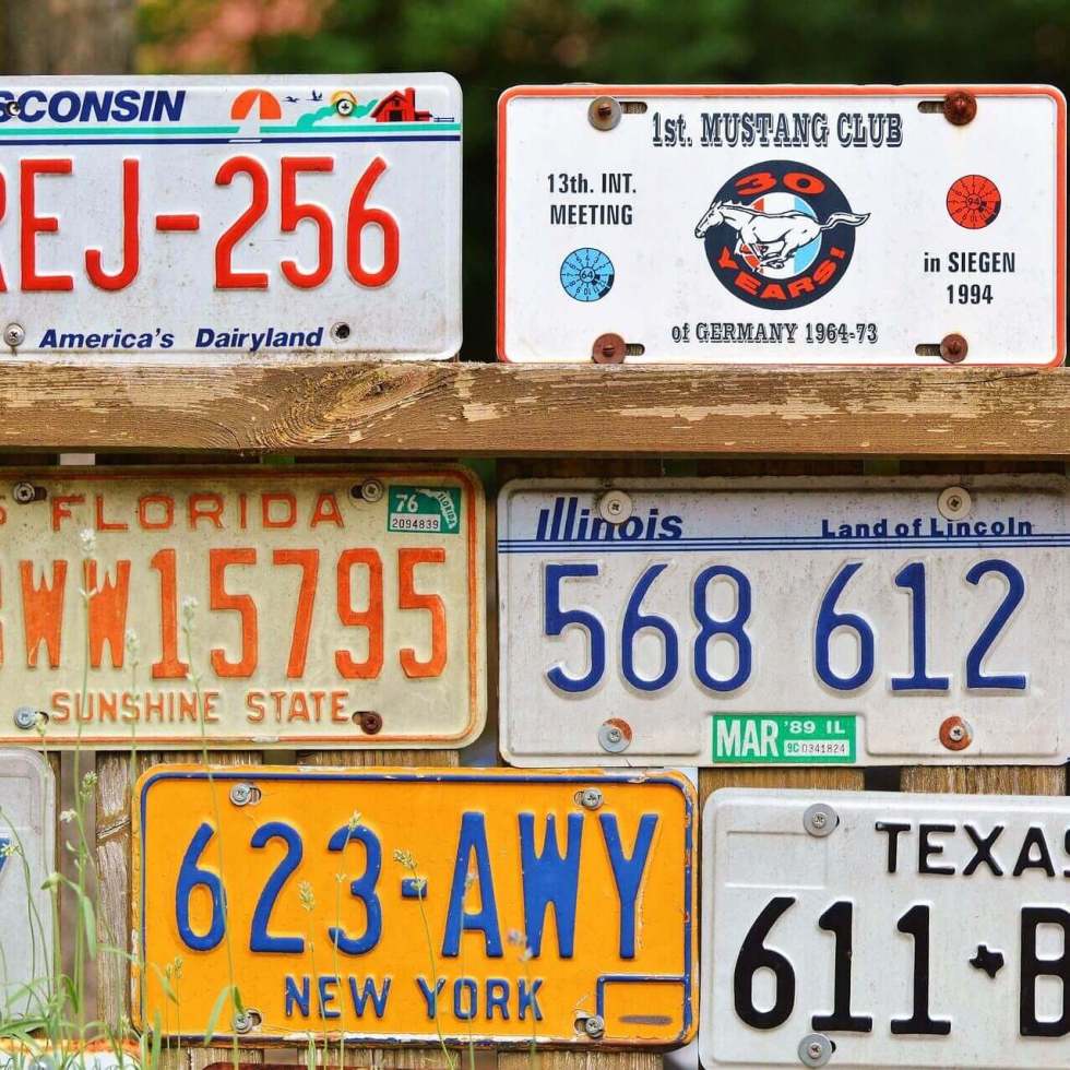 A collection of license plates illustrating vehicle-based digital parking permits.